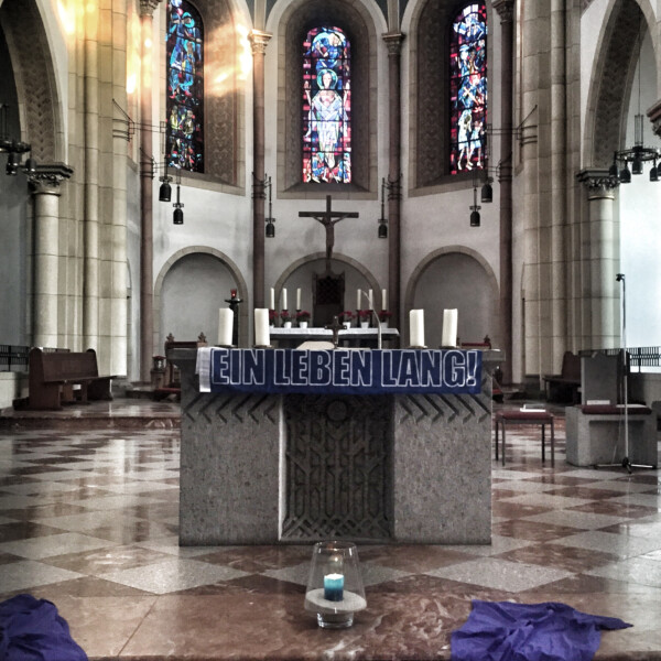 An einem Altar hängt ein Schal mit der Aufschrift "Ein Leben lang".